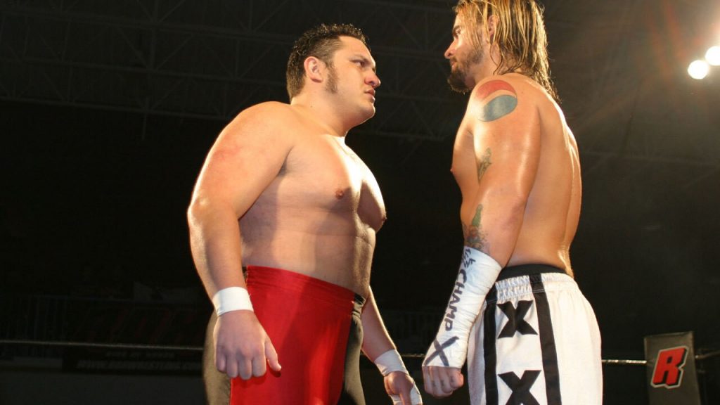 Samoa Joe and CM Punk confronting each other